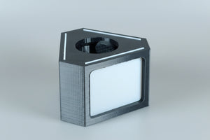 Black rectangular object with a circular opening on an white background